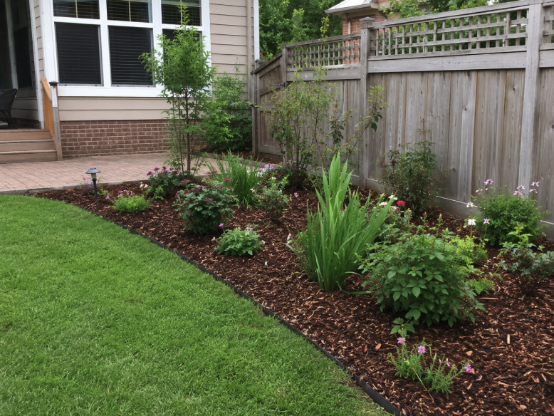 Landscaped Suburban Backyard Garden with Bark Mulch in the Flower Beds