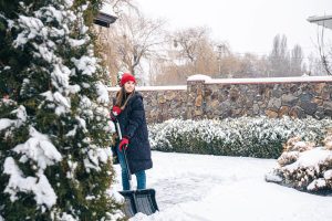 A lady standing in her snowy garden
