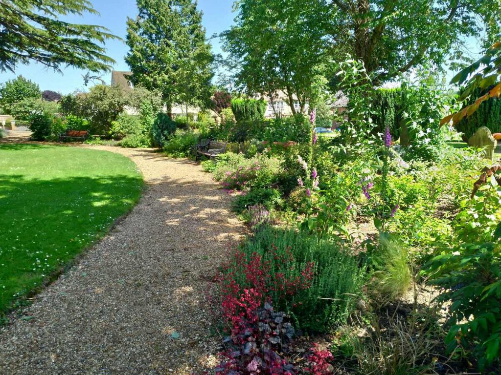 topsoil in salisbury - uk garden with a pebble path and flower border